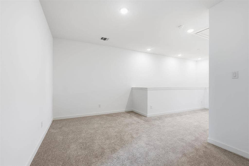7621 Dakota, Watauga, TX 76148 Carpeted room with recessed lighting and a white half-wall