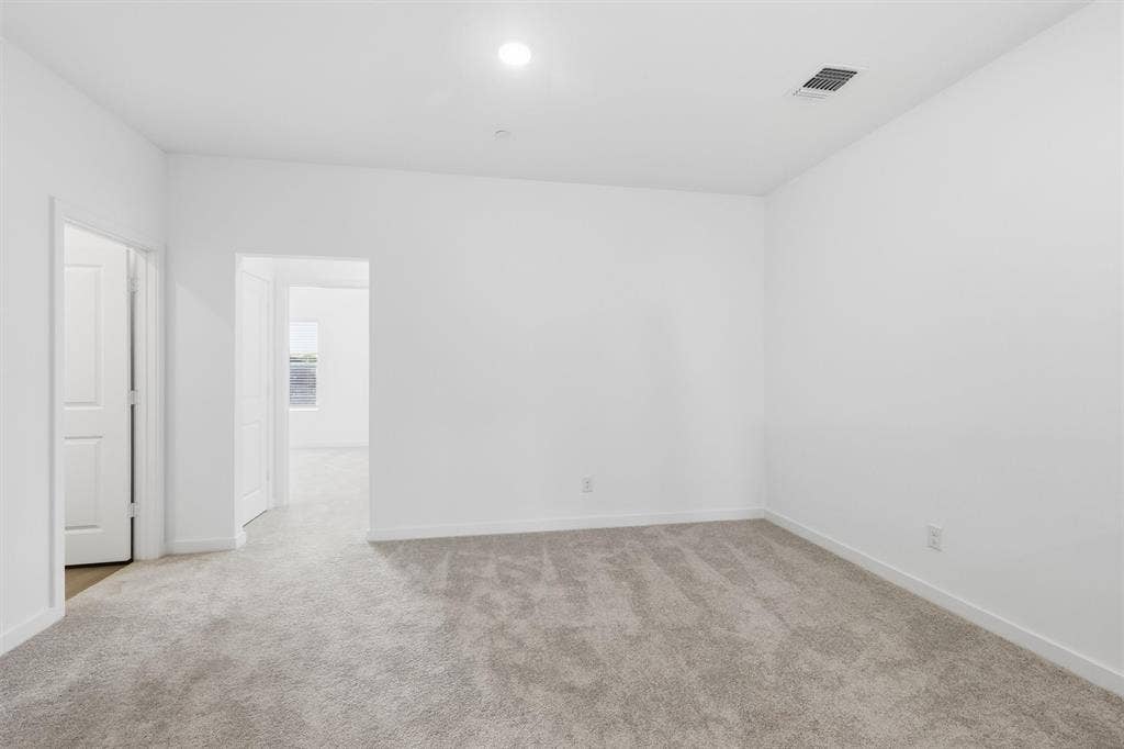 7621 Dakota, Watauga, TX 76148 Neutral tone wall finishes, recessed lighting, and soft carpet flooring