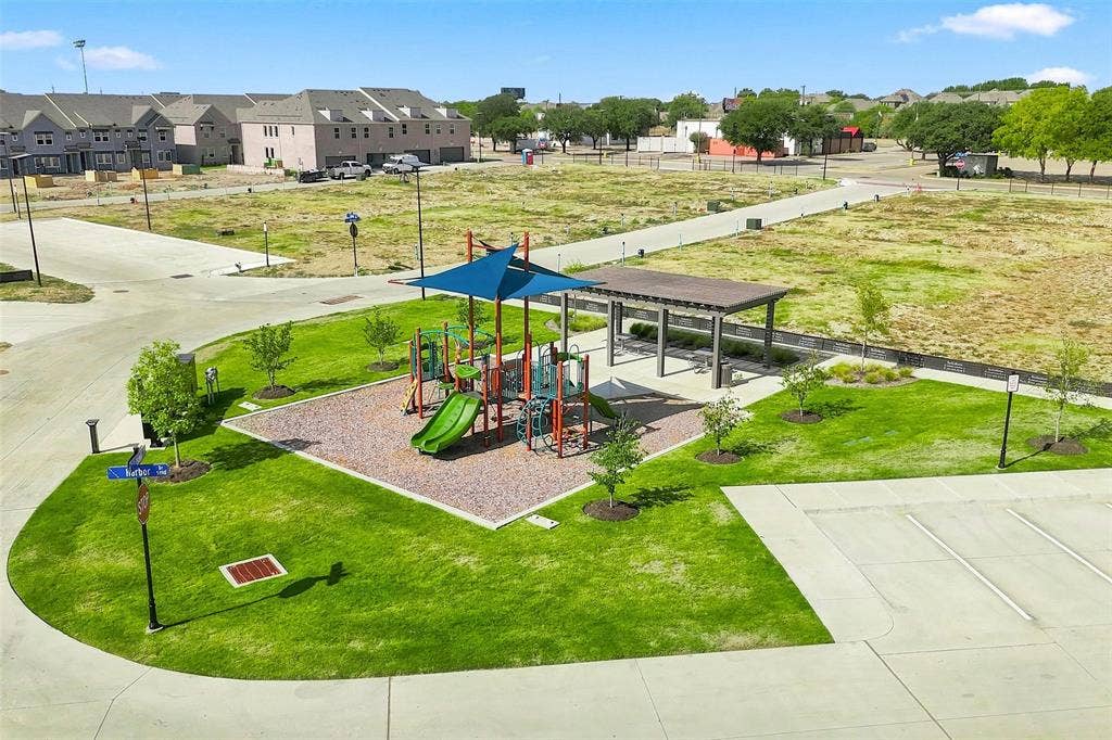 7621 Dakota, Watauga, TX 76148 Community playground with a shaded play structure, covered seating area, paved walking paths, and adjacent parking