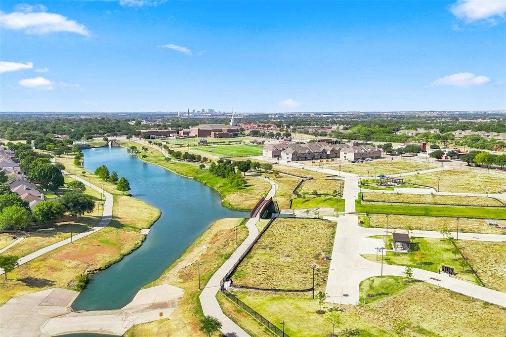 7621 Dakota, Watauga, TX 76148 Waterfront community with paved pathways, green spaces, and bridge access