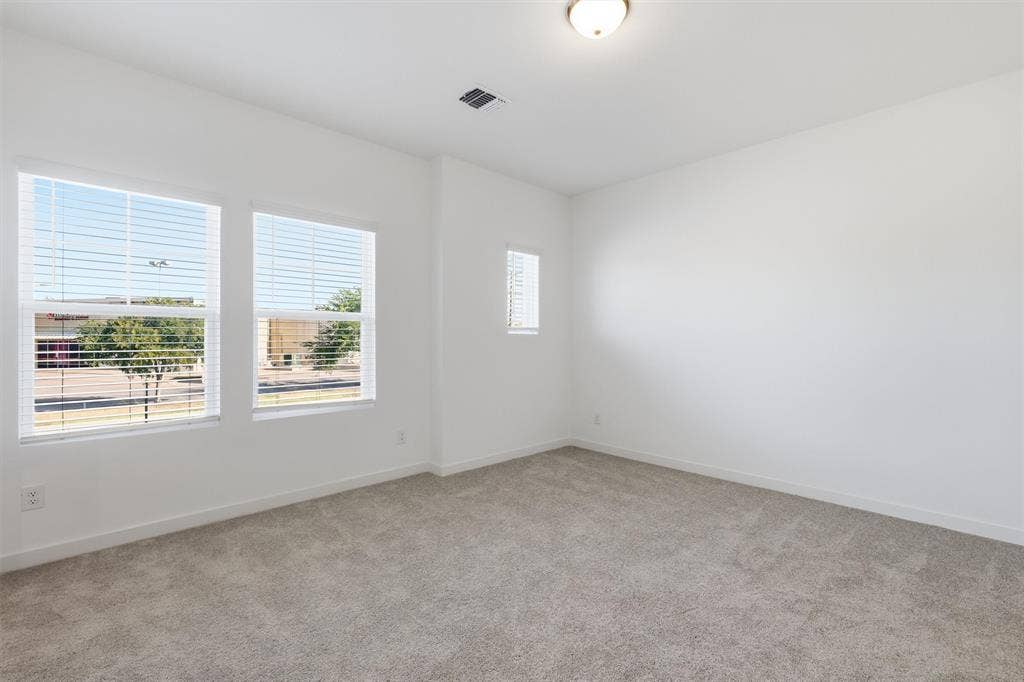 7621 Dakota, Watauga, TX 76148 Recessed ceiling light fixture, white walls, and light-colored carpet flooring