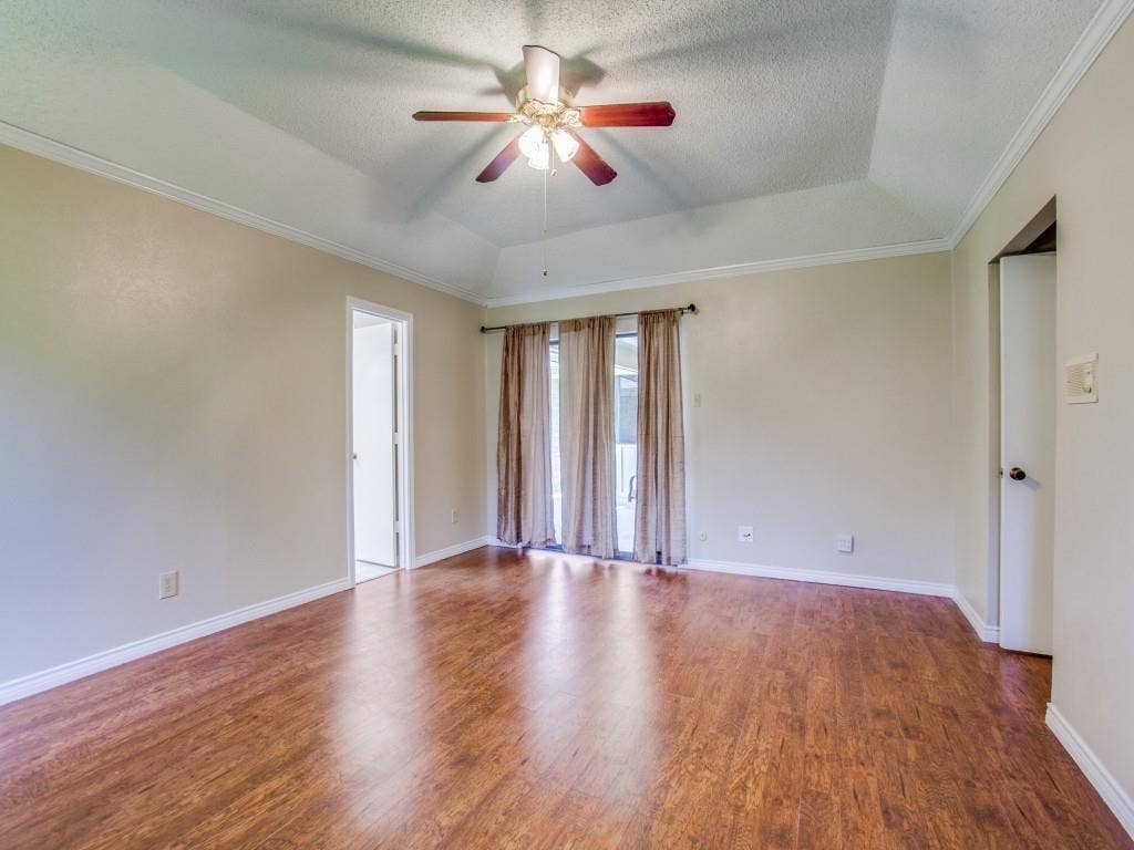 1103 Sundial Drive, Richardson, TX 75081 Tray ceiling with a ceiling fan, wood-finish flooring, and white trim