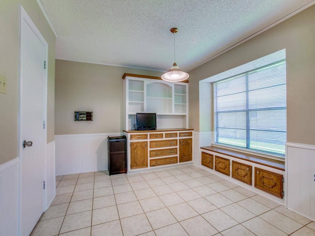 1103 Sundial Drive, Richardson, TX 75081 Tile flooring, built-in cabinetry with open shelving, built-in window seating with storage, and a pendant light fixture