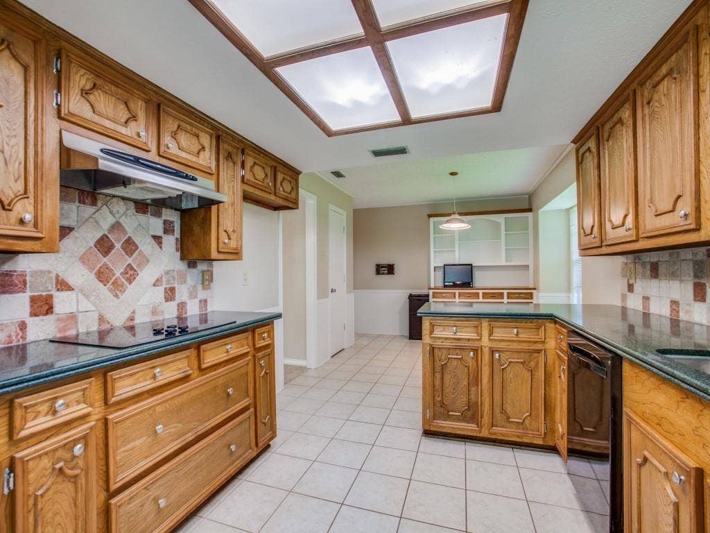 1103 Sundial Drive, Richardson, TX 75081 Kitchen with wood cabinetry, tiled flooring, built-in cooktop, and a ceiling-mounted light fixture
