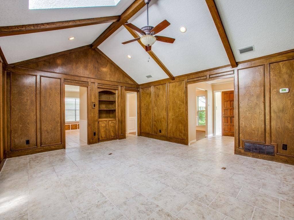 1103 Sundial Drive, Richardson, TX 75081 Vaulted ceiling with exposed wood beams, ceiling fan, recessed lighting, wood paneling, and ceramic tile flooring