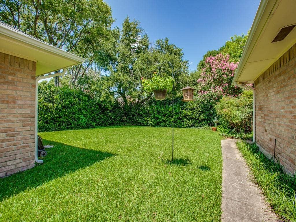 1103 Sundial Drive, Richardson, TX 75081 Expansive grassy area bordered by established trees and shrubs