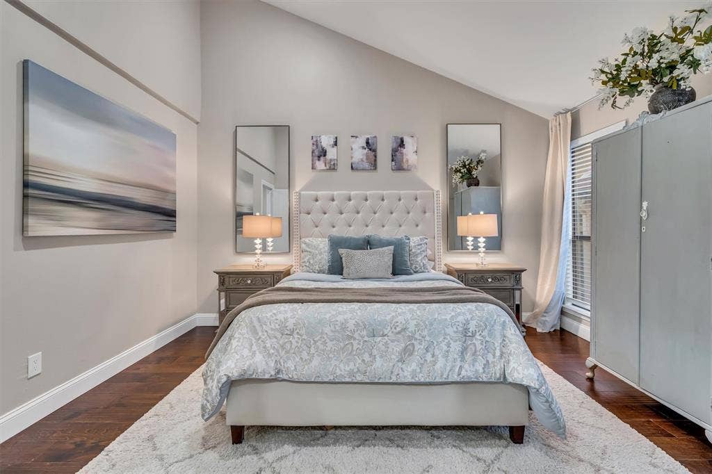 4242 Travis Street, #102, Dallas, TX 75205 Vaulted ceiling, dark wood-finish flooring, built-in window blinds, and black out curtains.