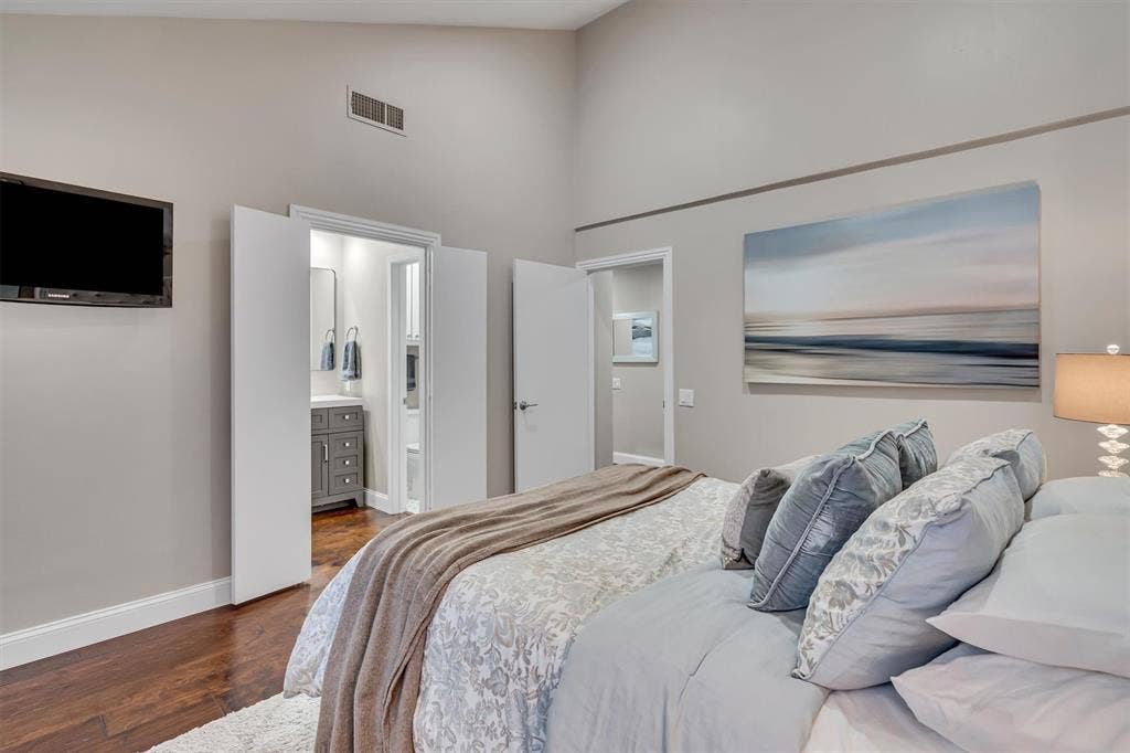 4242 Travis Street, #102, Dallas, TX 75205 Vaulted ceilings with recessed lighting, wood-finish flooring, and en-suite bathroom.