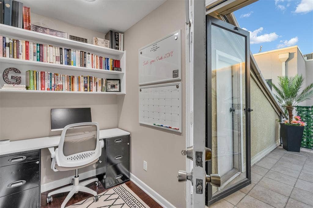 4242 Travis Street, #102, Dallas, TX 75205 Built-in wall shelving, wood-finish flooring, and direct access to an outdoor roof-top patio and storage room.