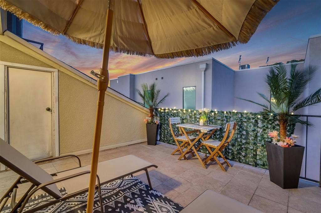 4242 Travis Street, #102, Dallas, TX 75205 Tiled outdoor rooftop patio featuring a privacy wall, storage room, integrated lighting, and perimeter railing