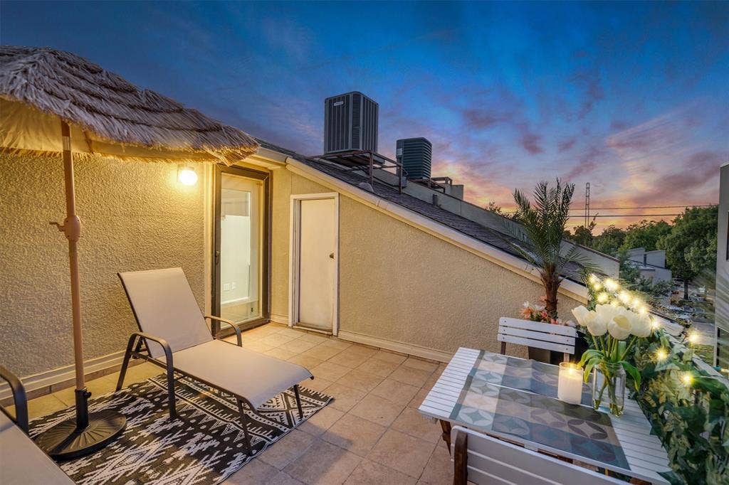 4242 Travis Street, #102, Dallas, TX 75205 Outdoor patio with tile flooring, wall-mounted exterior lighting, and a glass-paneled entry door