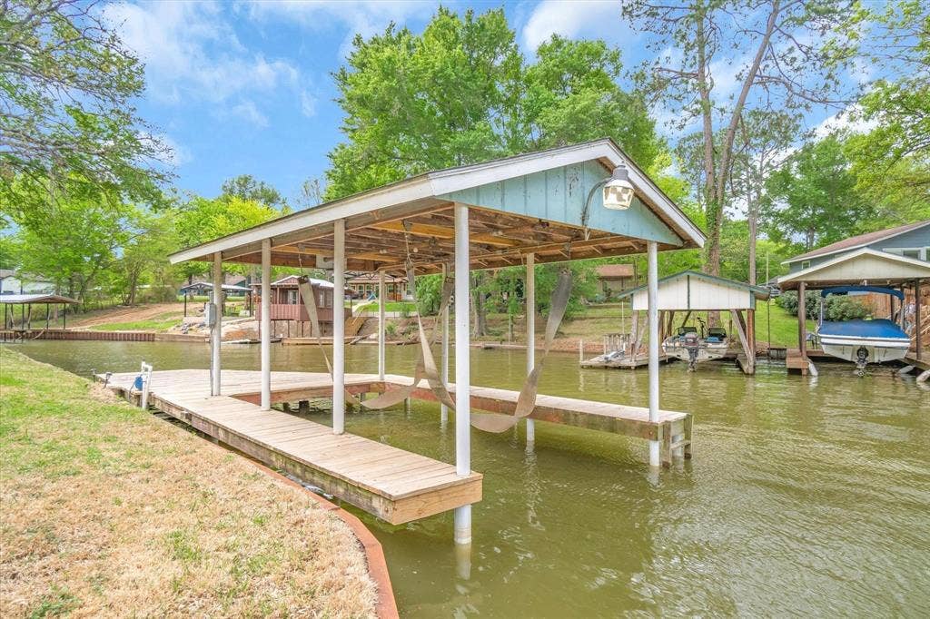 230 Shady Shores Drive, Mabank, TX 75156 Covered boat dock featuring a wood-finish walkway and a built-in light fixture
