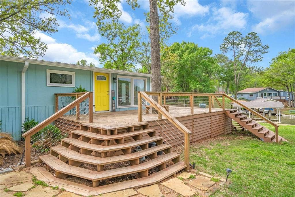 230 Shady Shores Drive, Mabank, TX 75156 Expansive wood deck with cable railing, multi-tier wood stairs, and direct water access