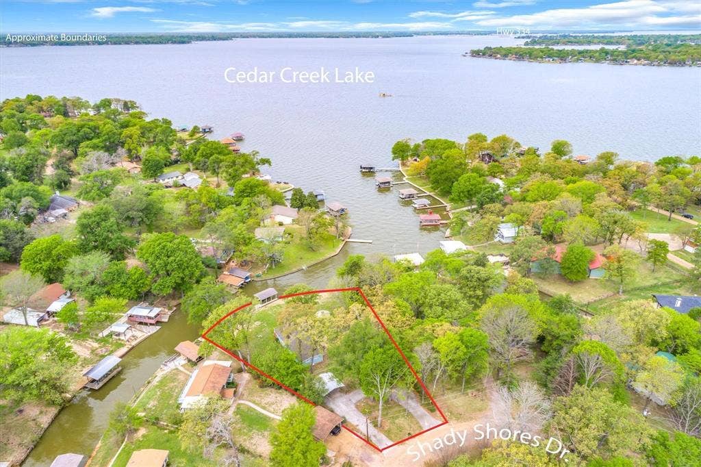 230 Shady Shores Drive, Mabank, TX 75156 Waterfront property featuring Cedar Creek Lake access, mature trees, and a private boat dock