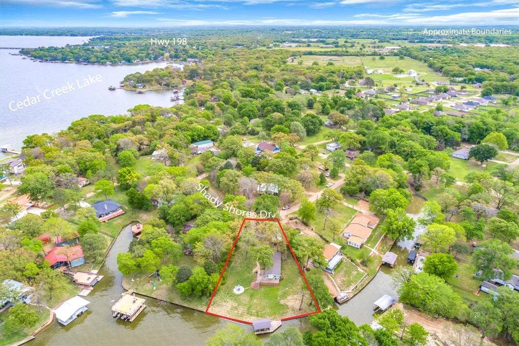 230 Shady Shores Drive, Mabank, TX 75156 Aerial perspective showcasing property within a lush, tree-filled landscape