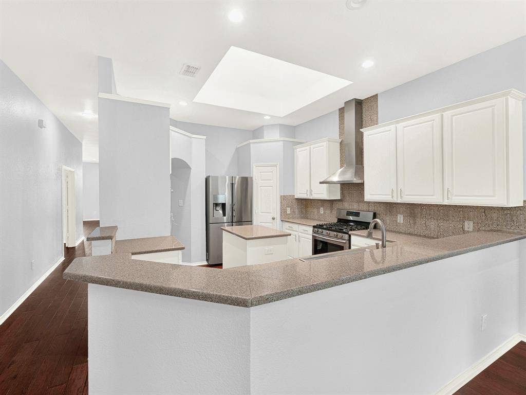 7409 High Point Drive, Sachse, TX 75048 Natural light flows into the kitchen from the huge skylight above