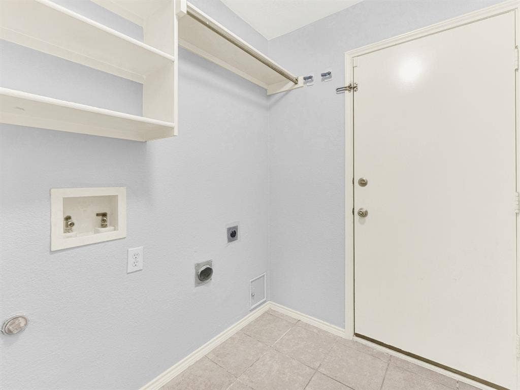 7409 High Point Drive, Sachse, TX 75048 Utility room has extra shelving rod to hang clothes