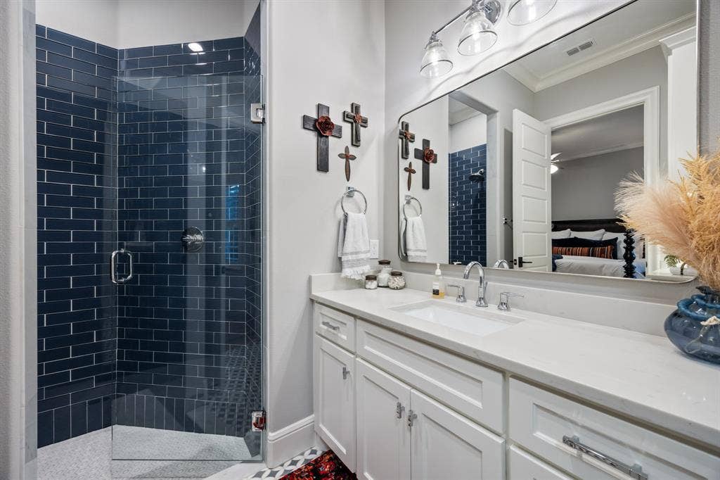 2201 Hanna Court, Midlothian, TX 76065 En-suite bath detailed with a dark tile shower surround and a single vanity.