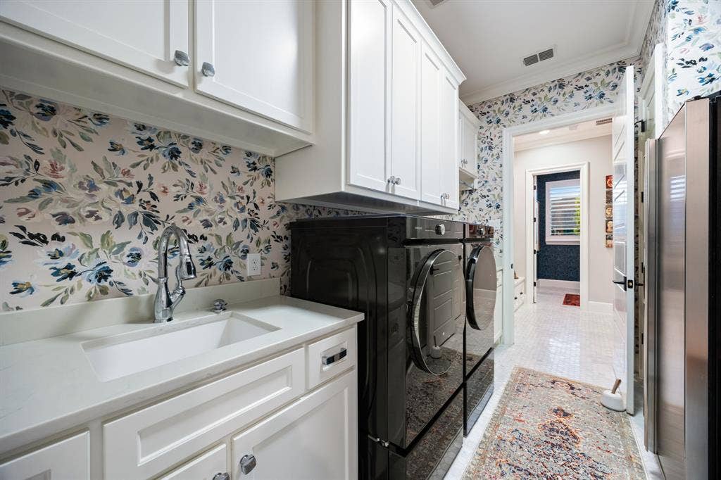 2201 Hanna Court, Midlothian, TX 76065 Laundry room finished with patterned tile and rich cabinetry, as stylish as the rest of the home.
