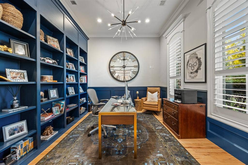 2201 Hanna Court, Midlothian, TX 76065 Private office wrapped in navy built-in shelving, a quiet spot for working from home.