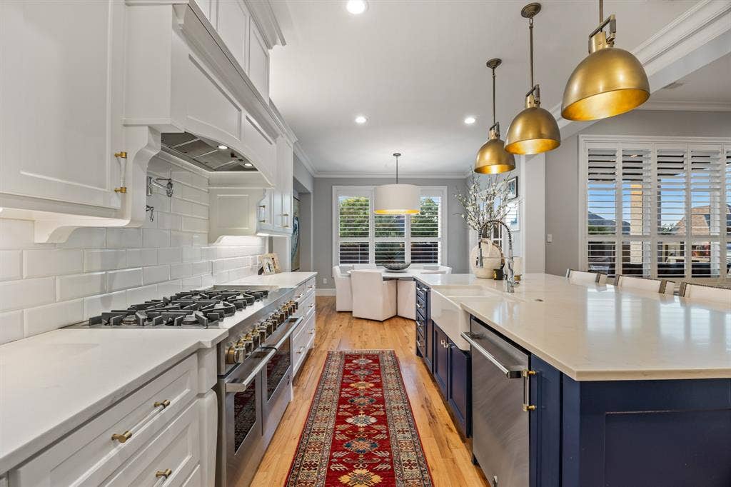 2201 Hanna Court, Midlothian, TX 76065 Island seating and a farmhouse sink make this kitchen as functional as it is beautiful.