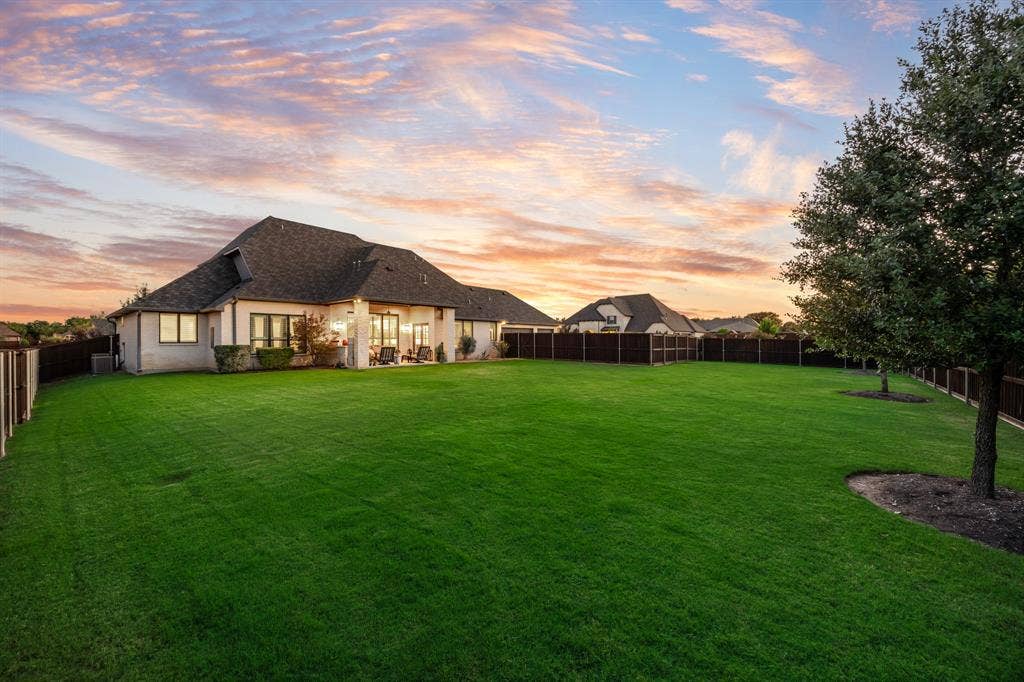 2201 Hanna Court, Midlothian, TX 76065 Nearly half an acre of lot space, framed by trees at along the fence.