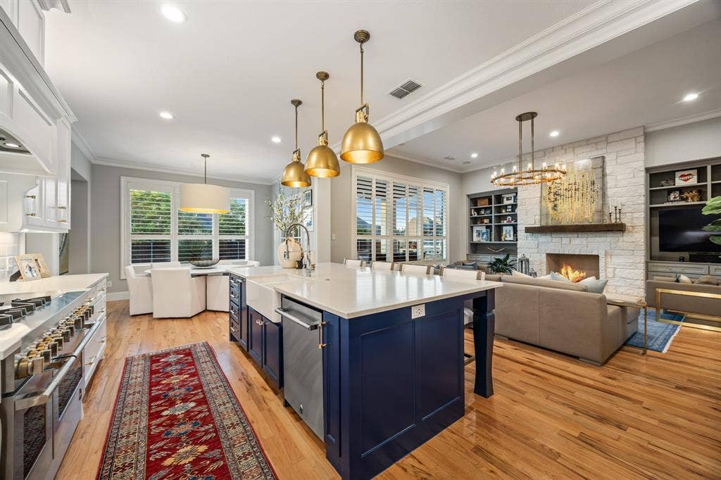 2201 Hanna Court, Midlothian, TX 76065 Chef's kitchen centered on an oversized island, finished with JennAir appliances and Restoration Hardware pendant lighting.