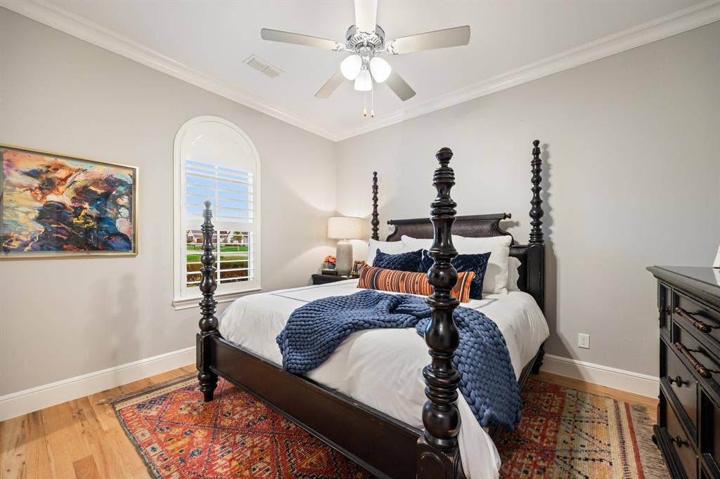 2201 Hanna Court, Midlothian, TX 76065 Downstairs secondary bedroom framed by an arched window, with room for a statement bed.