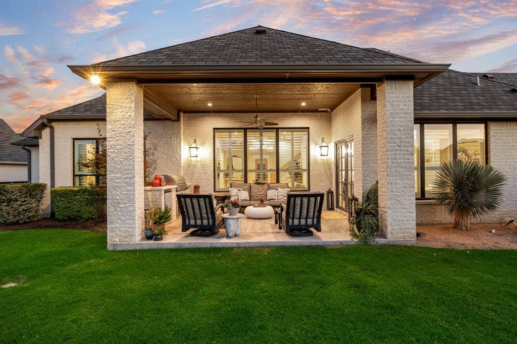 2201 Hanna Court, Midlothian, TX 76065 Outdoor kitchen made for long evenings, framed by a covered patio and warm lighting.