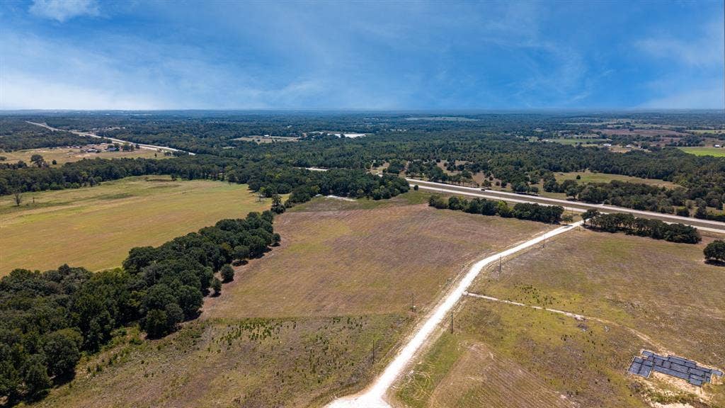 Lot 6 E US HWY 175, Athens, TX 75752 Expansive rural property featuring open fields and mature tree lines