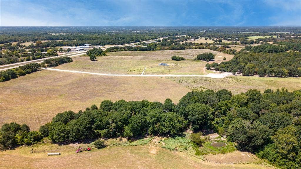 Lot 6 E US HWY 175, Athens, TX 75752 Expansive land parcel featuring wooded areas, open fields, and established access roads
