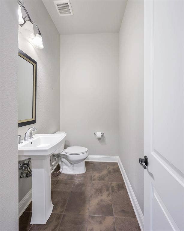 941 Leola Lane, Allen, TX 75013 Pedestal sink with chrome faucet, square framed mirror, and rectangular floor tiles