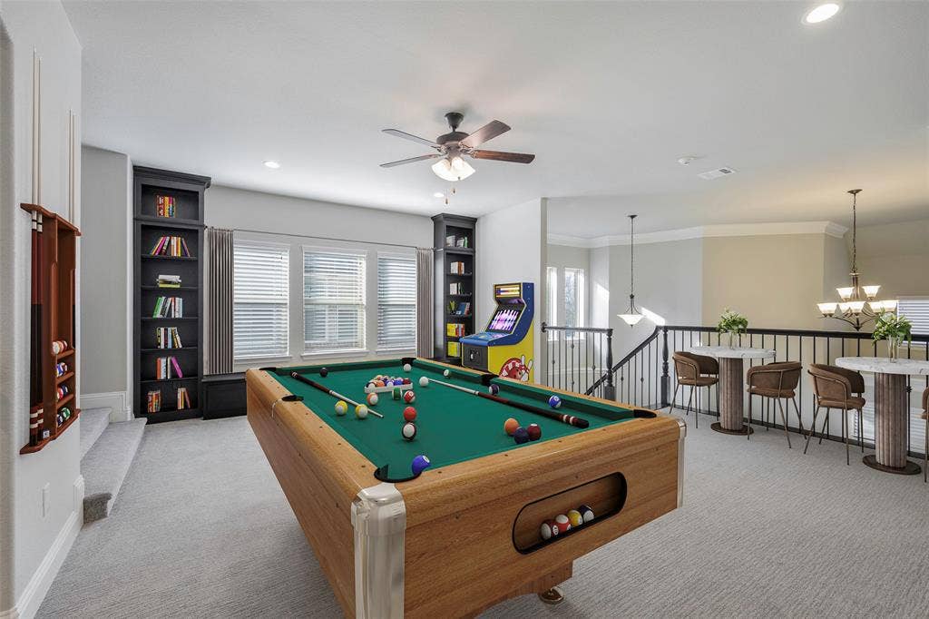 941 Leola Lane, Allen, TX 75013 Loft area featuring built-in shelving, ceiling fan, and carpeted flooring
