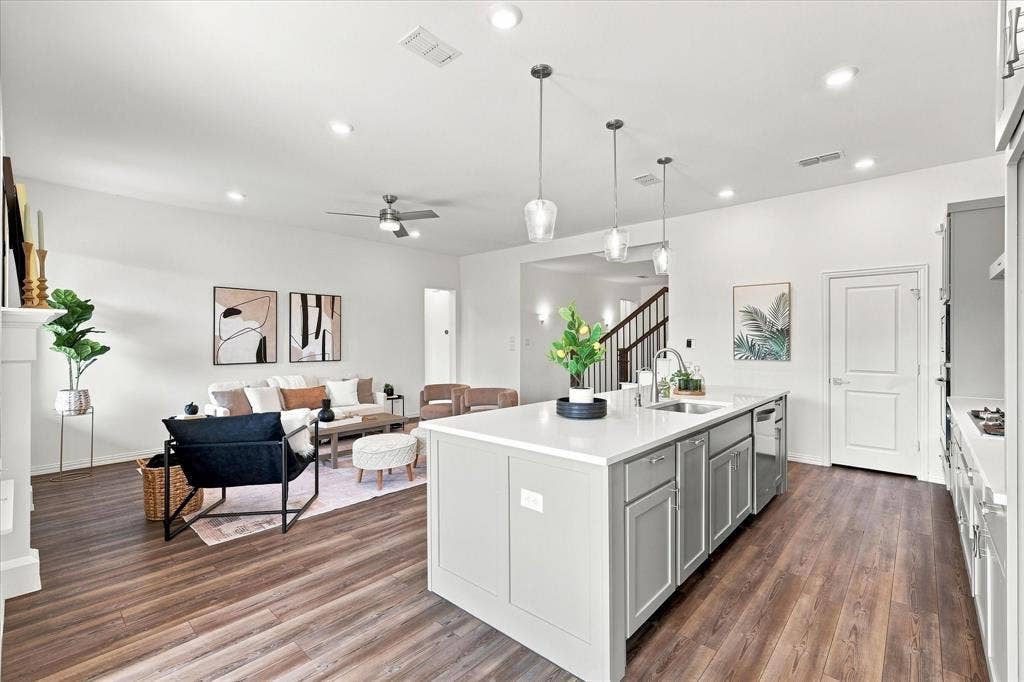 3109 Taunton Way, McKinney, TX 75069 Open-concept kitchen and living area featuring wood-finish flooring, recessed lighting, a ceiling fan, and a kitchen island with pendant lighting