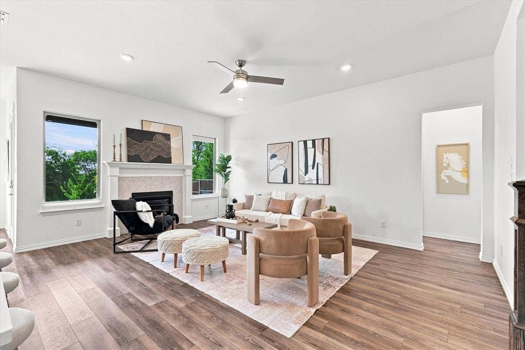 3109 Taunton Way, McKinney, TX 75069 Spacious living area featuring wood-finish flooring, a fireplace with a stone surround and mantel, recessed lighting, and a ceiling fan
