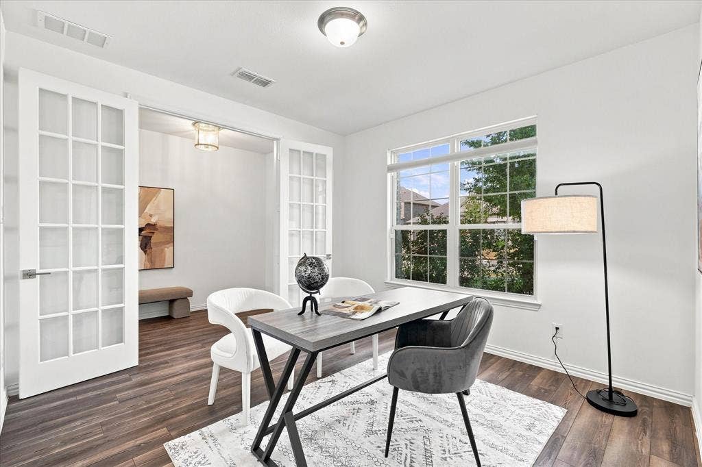 3109 Taunton Way, McKinney, TX 75069 Bright room featuring wood-finish flooring, a large window, and double French doors with frosted panes
