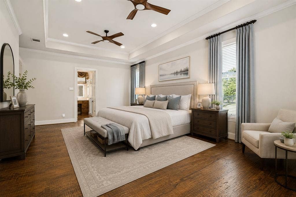 424 Wyndemere Boulevard, Heath, TX 75032 Spacious primary bedroom featuring hardwood flooring, a coffered ceiling with recessed lighting and ceiling fans, and dual nightstands with table lamps