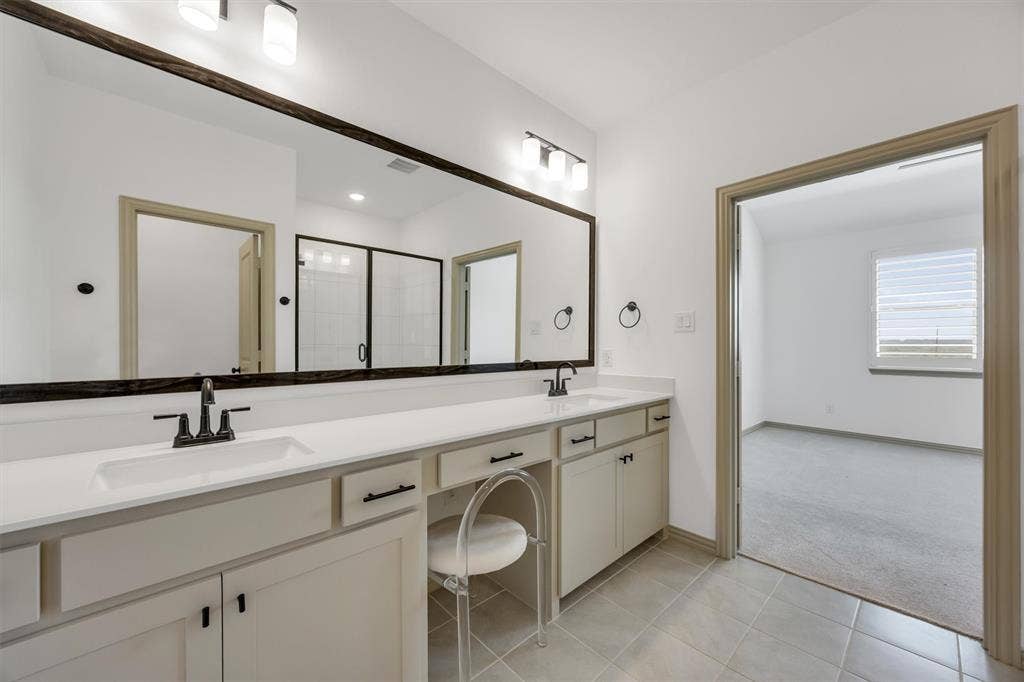 Primary ensuite bathroom with  dual sinks