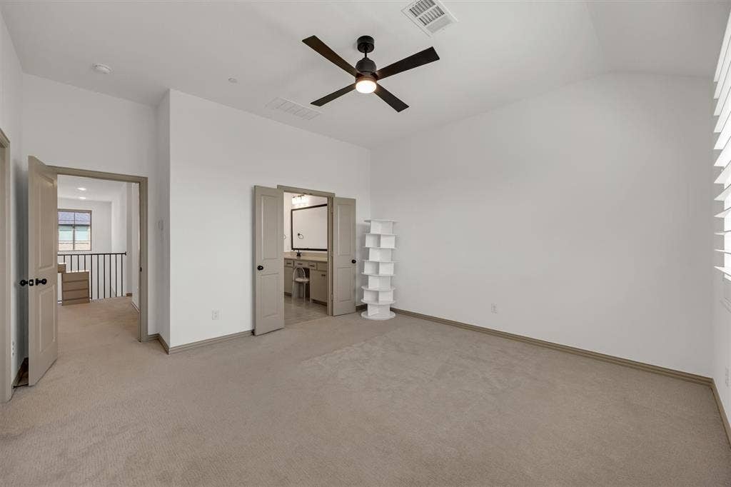Primary Bedroomvaulted ceilings, a ceiling fan, window with plantation shutters