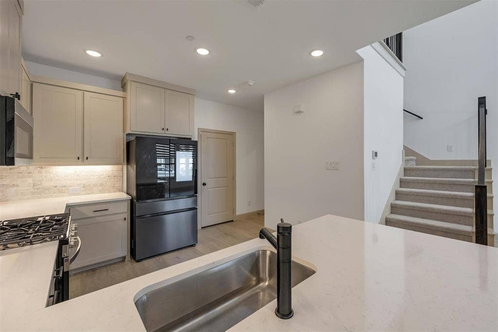 kitchen featuring an integrated sink with a matte black faucet