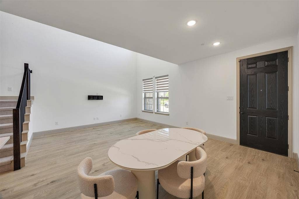 Vaulted ceilings enhance this open-concept room and a paneled entry door