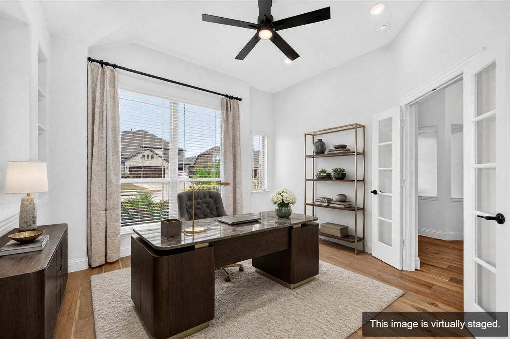 2600 Gavin Drive, Mansfield, TX 76063 Sophisticated home office featuring a dark wood executive desk, hardwood flooring, and abundant natural light from floor-to-ceiling windows