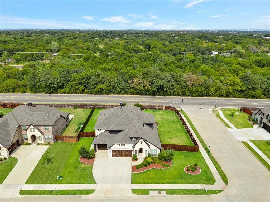2600 Gavin Drive, Mansfield, TX 76063 Aerial view showcasing this residence situated on a generous corner lot with manicured landscaping, circular driveway, and attached garage