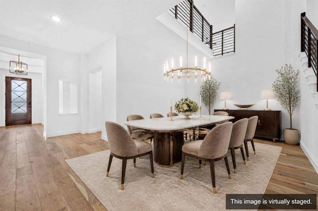 2600 Gavin Drive, Mansfield, TX 76063 Elegant dining space showcasing a round pedestal table, upholstered dining chairs, and a contemporary multi-pendant chandelier suspended from a coffered ceiling