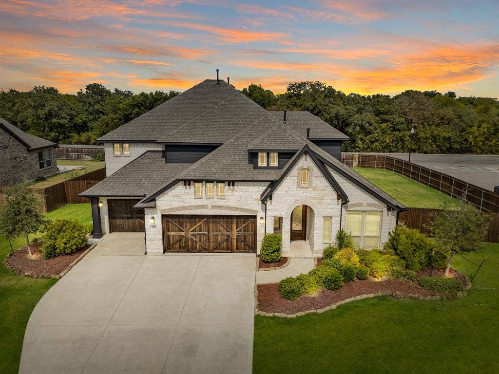 2600 Gavin Drive, Mansfield, TX 76063 Stunning white brick exterior with arched entryway and wood-finish garage doors