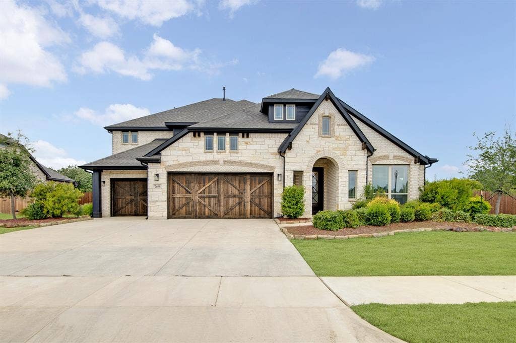 2600 Gavin Drive, Mansfield, TX 76063 Striking two-story residence featuring a stone and stucco exterior with peaked roofline and multiple gables