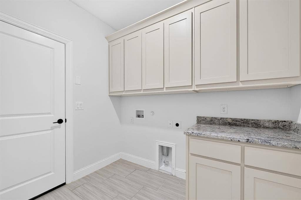 2600 Gavin Drive, Mansfield, TX 76063 Light-toned upper and lower cabinetry, stone-finish countertop, and durable tile flooring