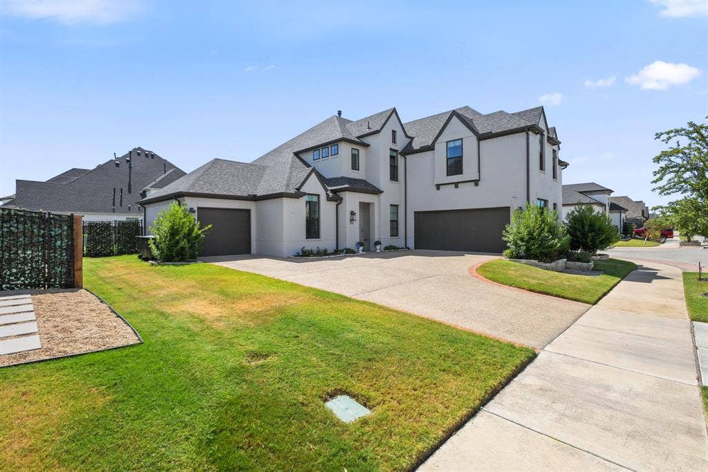 Contemporary two-story exterior with a light stucco finish