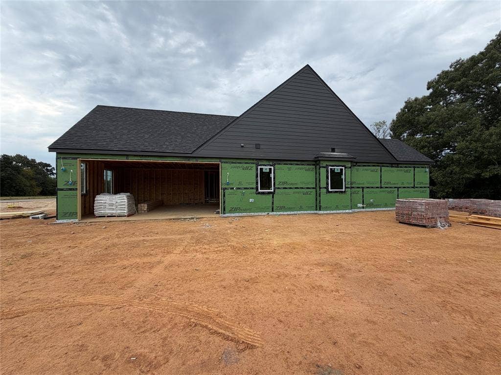338 Grace Lane, Athens, TX 75751 Side of home featuring side garage.