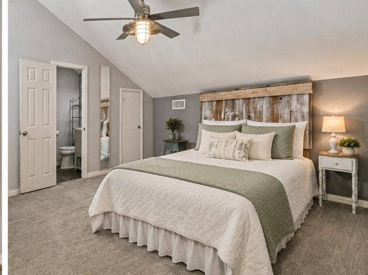 Angled ceiling, recessed lighting, ceiling fan with integrated light, wood-finish accent wall, and soft carpeting